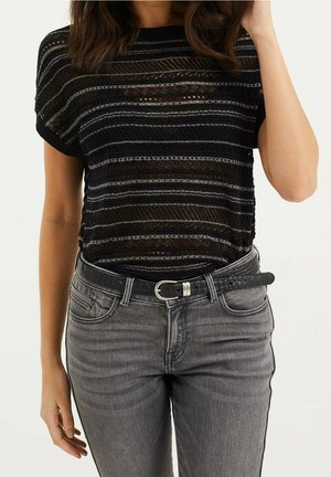 Black and gray striped knit top with short sleeves, paired with high-waisted gray jeans and a black textured belt with a silver buckle.