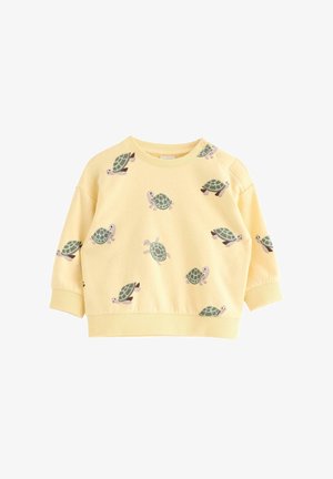 Sweat-shirt jaune à manches longues pour tout-petit avec des imprimés tortues verts et des boutons-pression sur une épaule.