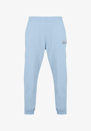 Pantalones deportivos de color azul claro con cinturilla elástica, piernas ajustadas y puños elásticos; presenta un parche con el logo de Kani Sports en un lado.