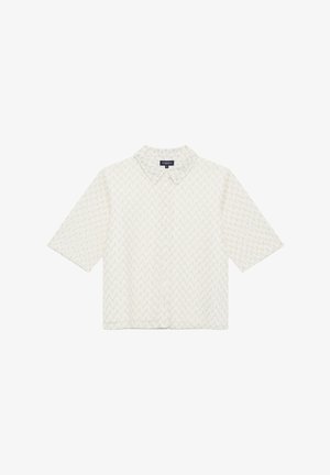 Camicetta a maniche corte color crema con un motivo a zigzag testurizzato, dotata di un collo a camicia e chiusura anteriore con bottoni. Finissaggio in tessuto morbido.