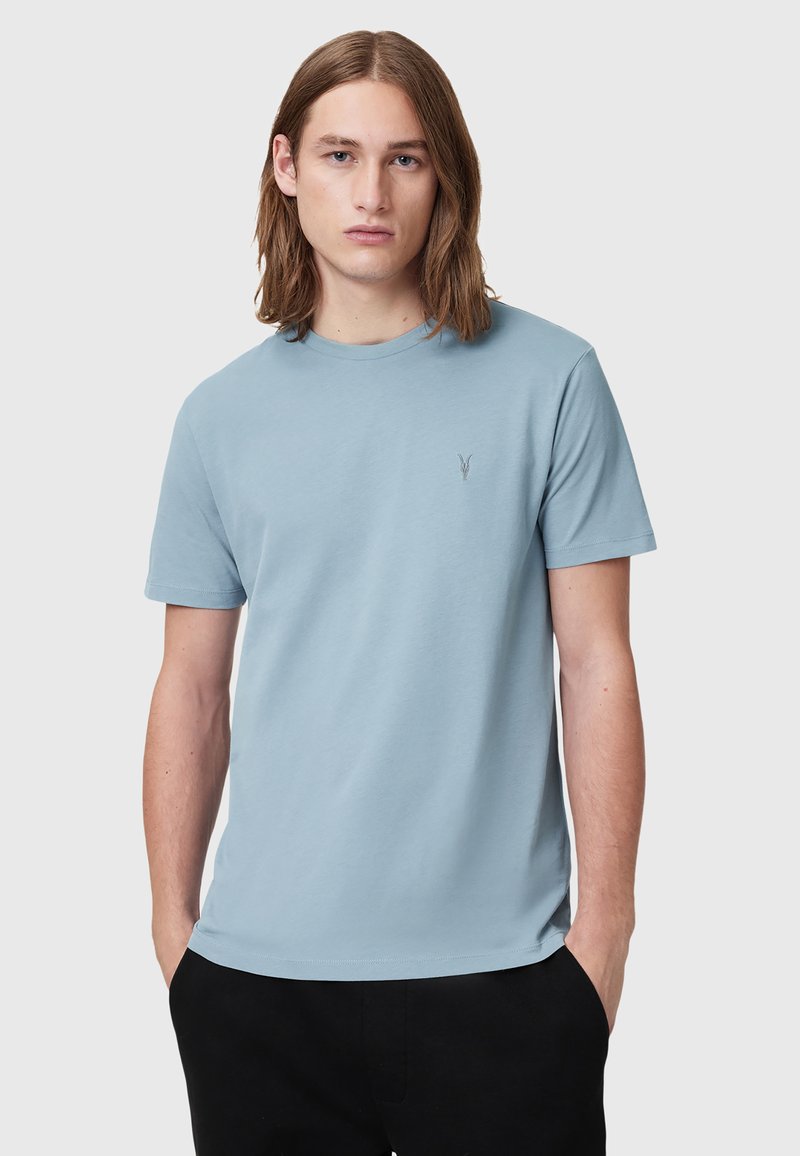 T-shirt di cotone azzurro chiaro con maniche corte e scollo tondo. Presenta un logo ricamato discreto sul petto. Tessuto morbido.