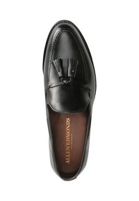 Schwarze Lederloafers mit glatter Oberfläche, versehen mit einem gestickten Design und dekorativen Quasten auf dem Vorderblatt. Braune Innenseite mit Markenlogo.