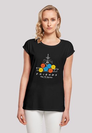 Black T-shirt with a graphic design featuring a central fountain, colorful umbrellas in orange, yellow, and blue, and "F.R.I.E.N.D.S" text.