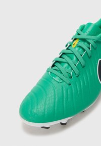 Green soccer shoe with textured synthetic upper, featuring black accent, white sole, and green laces. Design includes a rounded toe and sporty silhouette.