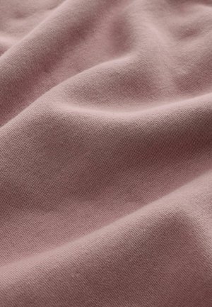 Cotton fabric in soft pink color, displaying a smooth, textured surface with subtle creases and folds. No patterns or hardware visible.
