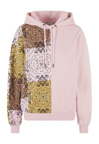 Hettegenser med rosa kropp; mønstrede lappverk i brunt, gult og hvitt med intrikate design; snøring og ribbestrikkede mansjetter.