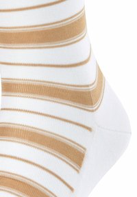 Gestreifte Socken in Weiß und goldbeige, gefertigt aus weichem Material mit glatter Textur und kontrastierenden Streifen.