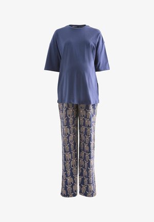 Marineblå bomulds-T-shirt med korte ærmer og afslappet pasform, kombineret med mønstrede bukser med elefanter i guld og marineblåt på en blød baggrund.