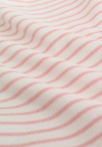 Puha pamutanyag, hullámos mintával, vékony rózsaszín csíkokkal fehér alapon, sima textúrát és könnyű esést mutatva.