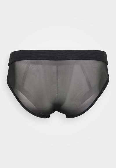 Čierne priesvitné spodné prádlo s nízkym pásom a hladkými okrajmi. Materiál má ľahkú, nepriehľadnú kvalitu a priliehavý strih.