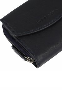 Navy leather wallet with a textured finish, zip closure, and embossed branding. It features contrasting stitching and a smooth flap.