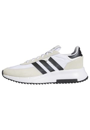 Valkoinen ja beige lenkkari, jossa mustat kolme raitaa, valkoiset nauhat ja mustavalkoinen kuvioitu pohja, nähtynä sivulta.