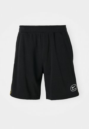 Schwarze Sportshorts aus weichem Material, mit einem elastischen Bund, Logodetail und kontrastierenden gelben Streifen an den Seiten.