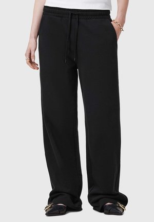 Zwarte sweats met een elastische tailleband en verstelbare trekkoord. Voorzien van zijzakken en een relaxte pasvorm. Zachte stoftextuur.