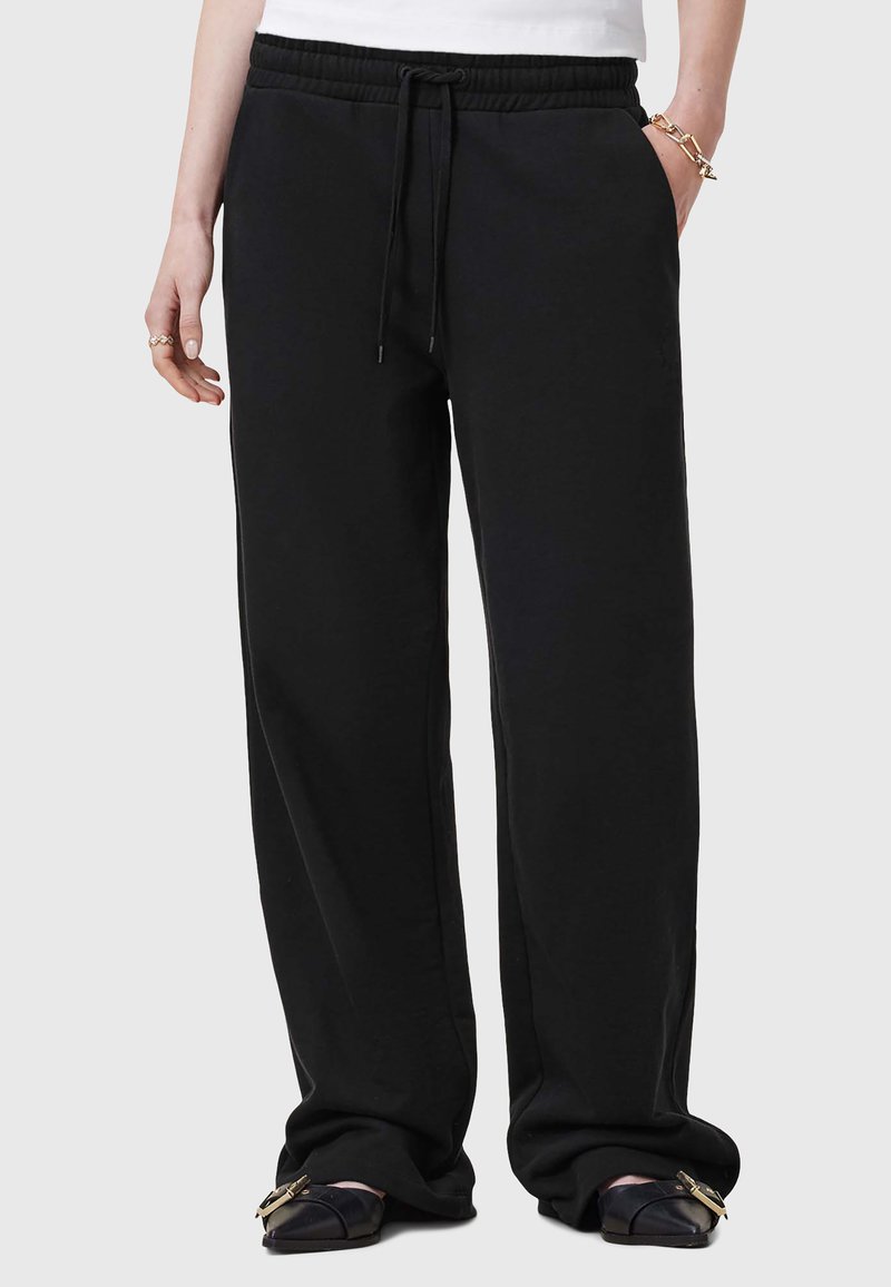 Zwarte sweats met een elastische tailleband en verstelbare trekkoord. Voorzien van zijzakken en een relaxte pasvorm. Zachte stoftextuur.