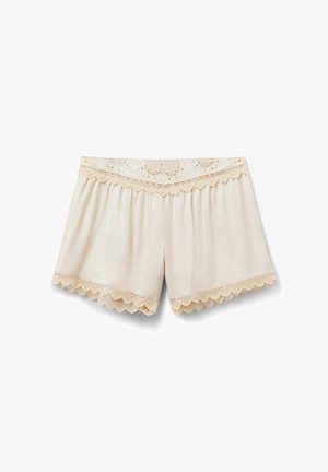 Pantalones cortos para mujer de color crema con borde de encaje en ondas en la cintura y aberturas de las piernas, con patrones bordados florales y geométricos.