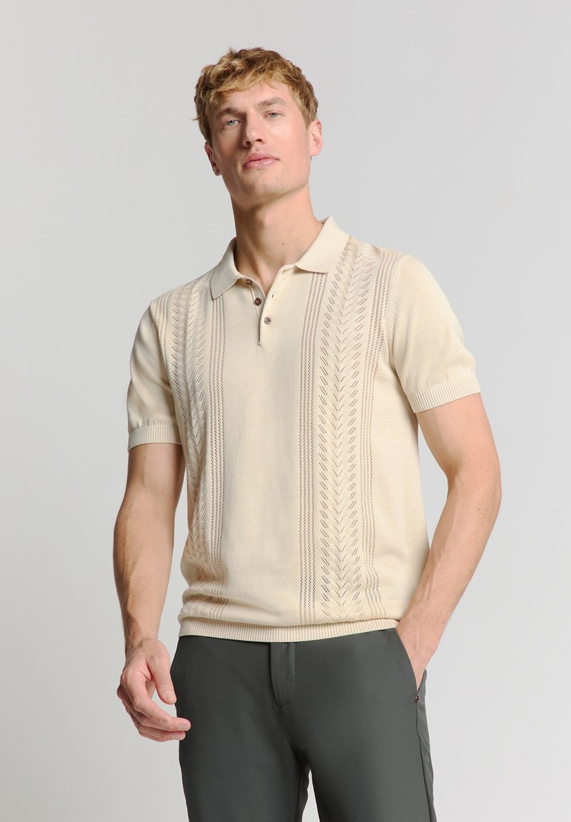 Gebreide polo shirt in lichtbeige met korte mouwen, voorzien van een gestructureerd patroon van verticale lijnen en een drieknopenlijst.