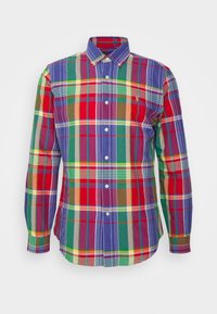 Camicia a quadri multicolore con bottoni e maniche lunghe, caratterizzata da motivi rossi, verdi, blu e gialli, realizzata in tessuto leggero.