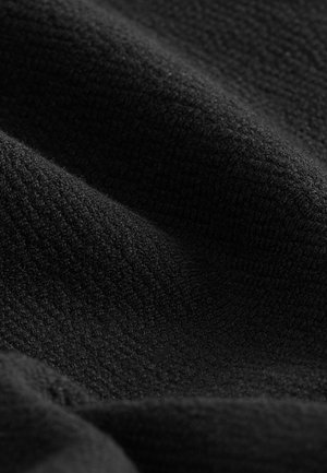 Black textured fabric with a soft, fuzzy surface. Features a subtle ribbed pattern, suitable for various applications.