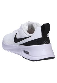 White athletic shoe featuring a textured upper, black accent on the heel, and a padded collar. The sole has a visible air cushioning unit.