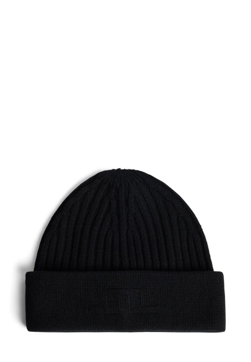 Bonnet en tricot côtelé noir avec un revers replié, présentant un logo subtil embossé sur le revers. Le matériau est doux et texturé.