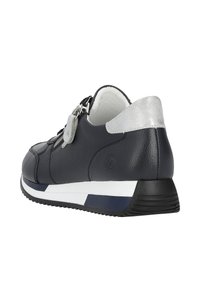 Marineblaue Leder-Sneaker mit einem silbernen Akzent an der Ferse, seitlichem Reißverschluss und einer weiß-marineblauen gestreiften Sohle für zusätzlichen Kontrast.