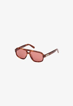 Occhiali da sole tartaruga marrone con lenti rosa. Caratterizzati da un design angolare e dal logo del marchio "GCDS" in bianco sulla tem prop.