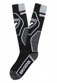 Calcetines de esquí negros con acentos grises, patrones hexagonales y el logo de "Rossignol". Puño acanalado para un ajuste ceñido. Textura suave.