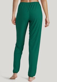 Groene polyester broek met een elastische tailleband, tapered leg ontwerp en gathered cuffs. Zachte textuur, geschikt voor casual kleding.