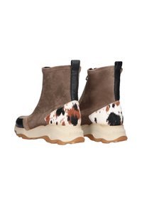 Brown suede ankle boots feature a black textured leather heel tab and a spotted cowhide accent. Rubber sole with a prominent design.