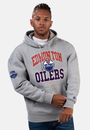 Gray hoodie featuring "EDMONTON OILERS" logo in orange and blue, with NHL Western Conference patch on the left sleeve. Cotton blend material.