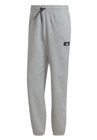 Graue Sweatpants aus weichem Stoff, mit einem elastischen Taillenbund und Kordelzug, Seitentaschen und einem kleinen schwarzen Logopatch.