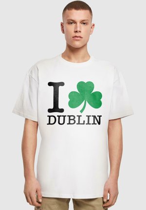 White cotton t-shirt featuring the text "I ❤️ DUBLIN" with a green shamrock. The shirt has a relaxed fit and short sleeves.