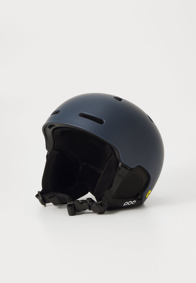 Matte navy ski helmet featuring ventilation slots, soft inner padding, adjustable chin strap, and accent logo on the side.