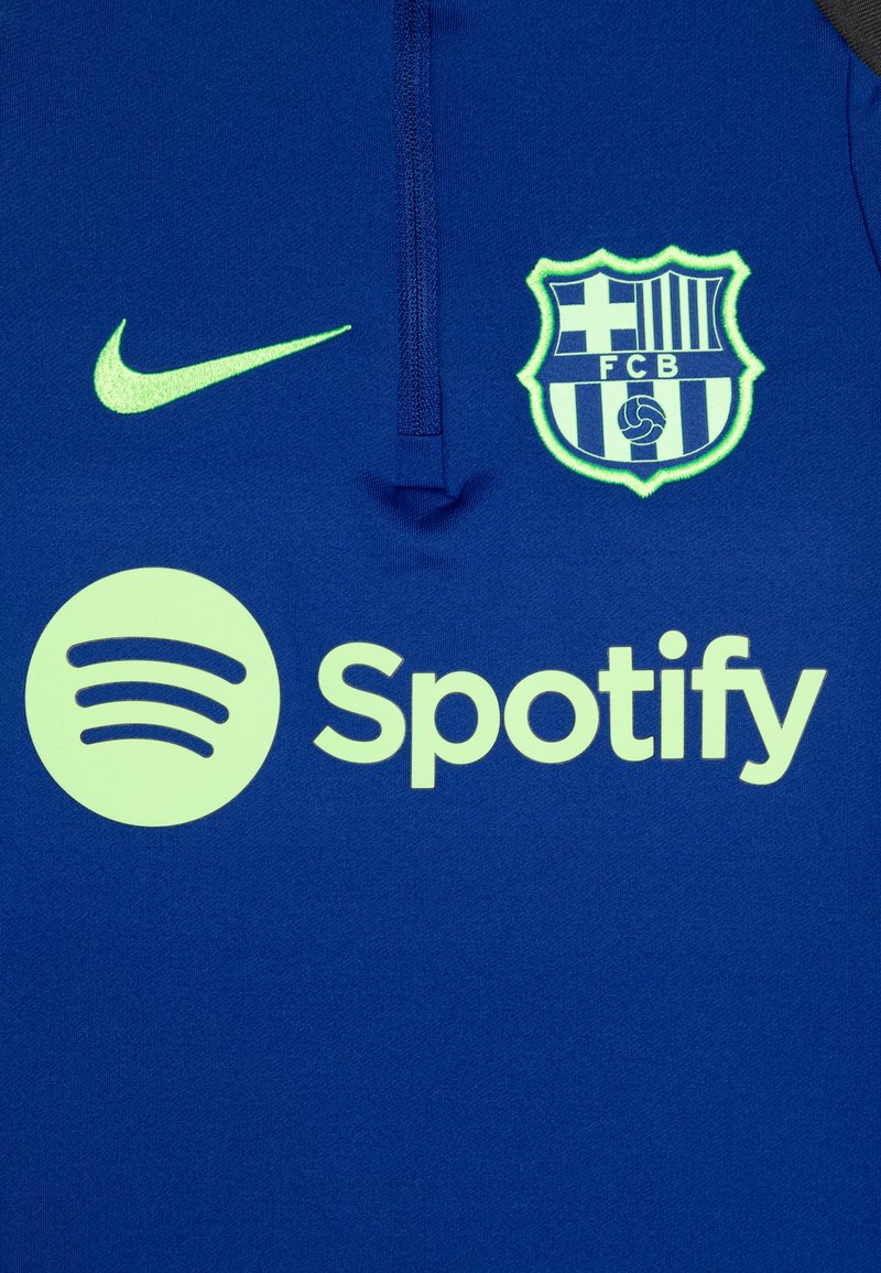 Nike Fußballtrikot in Blau mit lebendigen grünen Akzenten. Zeigt das FC Barcelona-Logo und das Spotify-Branding, mit einem Reißverschlusskragen.