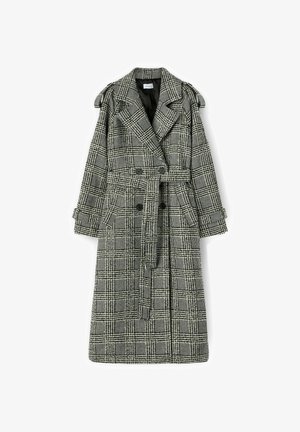 Grau-schwarzer karierter Trenchcoat, doppelt brustig mit einem Gürtel in der Taille, seitlichen Taschen und Schulterklappen. Texturiertes Material.