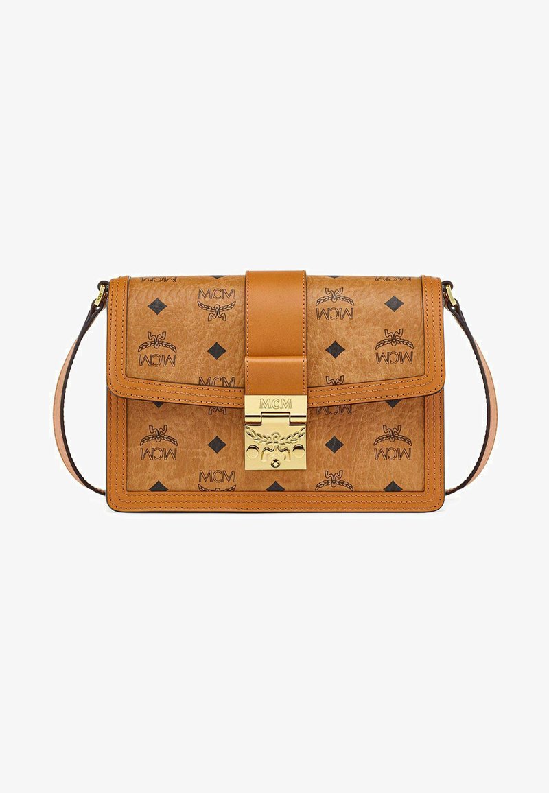 Tan leather bag featuring embossed MCM logos and black diamond patterns, with a gold clasp and a detachable shoulder strap.