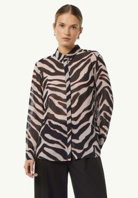 Transparent, long-sleeve shirt with black, white, and red zebra stripes, featuring a button-down collar and front placket detail.