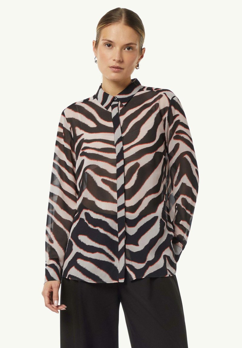 Transparent, long-sleeve shirt with black, white, and red zebra stripes, featuring a button-down collar and front placket detail.