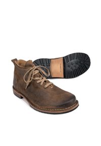 Brown leather ankle boots with rounded toe, lace-up front, cushioned collar, and rubber sole featuring treads for grip.