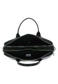 Svart läderhandväska med två dragkedjefack, dubbla handtag upptill och en slät yta. Inuti är väskan foder och rymlig.