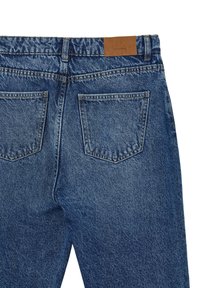 Jeans in denim blu con un taglio classico. Presentano due tasche posteriori, cuciture decorative e un'etichetta in pelle marrone sulla vita.