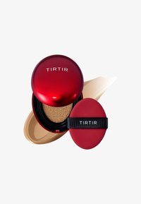 Red compact with TIRTIR logo, containing cushion foundation and applicator. Features round shape, glossy finish, and gold cushion inside.