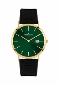 Goldene Armbanduhr mit einem tiefgrünen Zifferblatt, verlängerten Stundenmarkierungen, Datumsanzeige bei 6 Uhr und einem schwarzen Lederarmband im Krokodil-Muster.