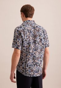 Camicia a maniche corte con motivo floreale nei toni di blu, bianco, marrone e verde. Realizzata in tessuto leggero con design colletto.