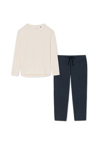 Ljusbeige långärmad topp med rund hals, tillsammans med marinblå pyjamasbyxor med ett vitt prickmönster och dragsko i midjan.