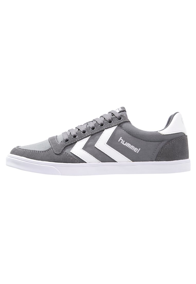 Sneaker in tela grigia con accenti bianchi, caratterizzati da un design con lacci, punta arrotondata e suola in gomma. Logo del marchio visibile sul lato.