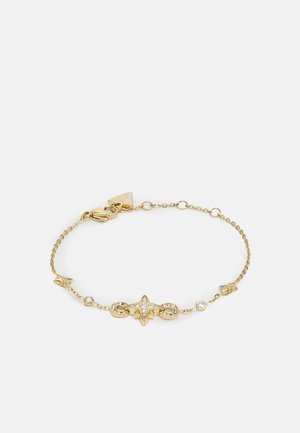 Delicate gouden kettingarmband met een centraal stervormig bedeltje versierd met kleine heldere kristallen en extra edelsteenaccenten langs de ketting.