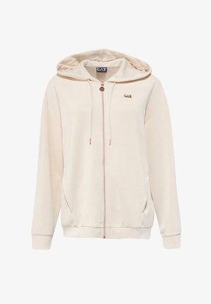 Felpa crema realizzata in tessuto morbido, con zip frontale, tasche laterali e cappuccio con cordino. Dettaglio del logo dorato sul petto.