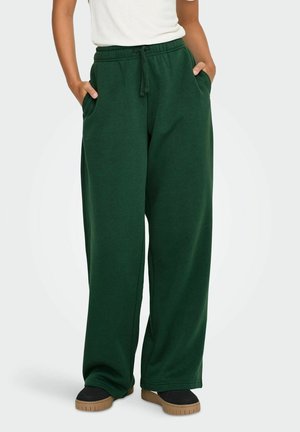 Grønne, vide sweatpants lavet af blødt, tekstureret stof. Funktionen inkluderer en elastisk talje med snoretræk og sidelommer.